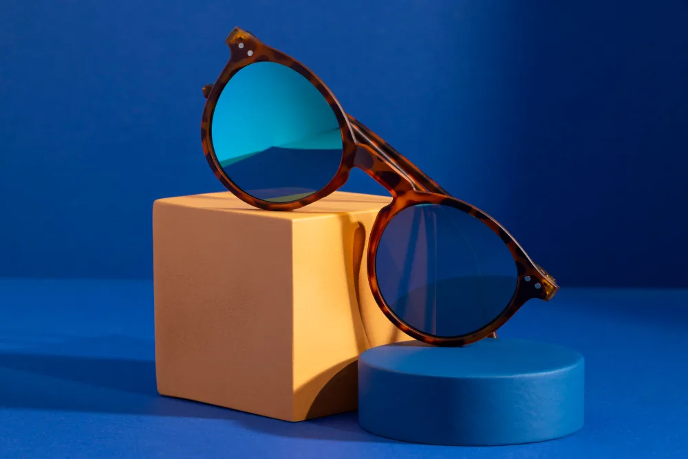 Round tortoiseshell sunglasses on a studio display